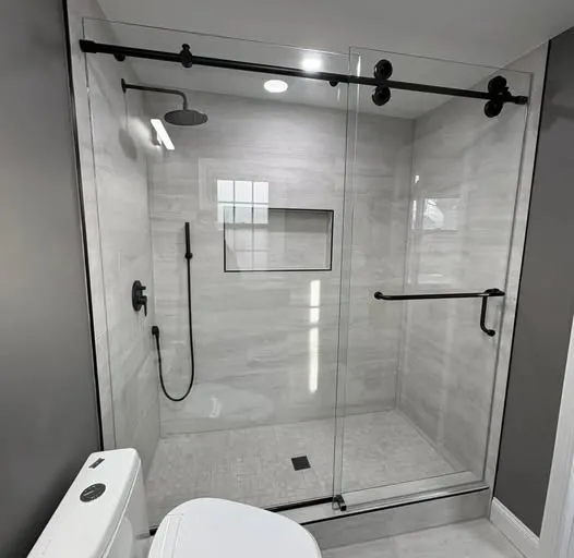 Black-hardware sliding glass shower door